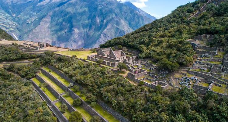 Ruinas de Choquequirao con laderas en terrazas y montañas.
