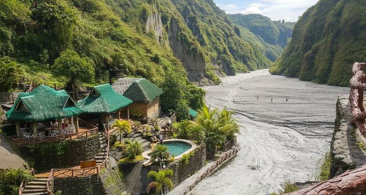 Pool and lodges in a canyon setting with riverbed.