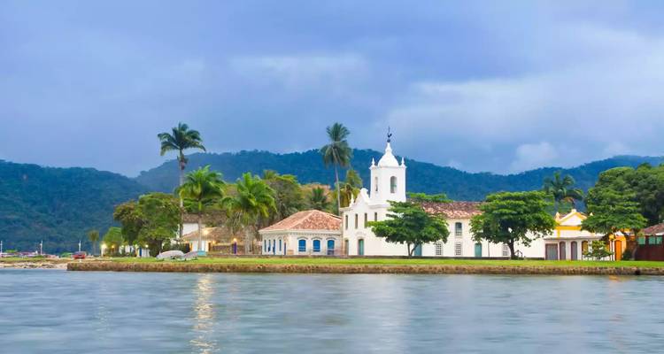 Colonial-style church and buildings by the water.