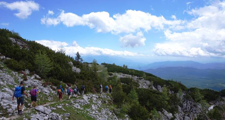 Grupo de excursionistas en un sendero rocoso de montaña.