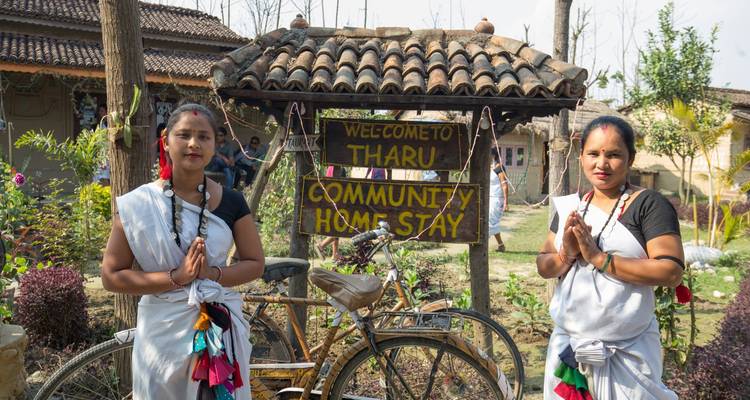 Two women in traditional dress at a community homestay.
