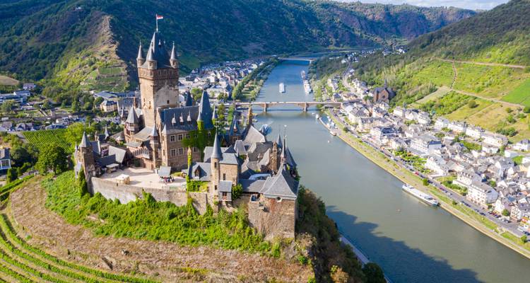 Vue aérienne spectaculaire du château de Cochem au sommet des vignobles surplombant la Moselle.