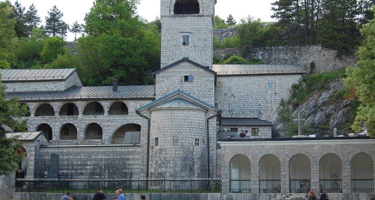 Monasterio construido de piedra, situado contra una exuberante vegetación.