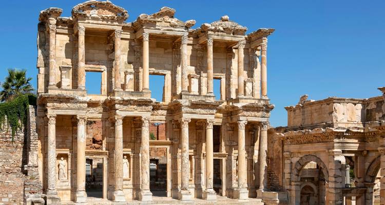 Ancient library ruins with detailed stone carvings and columns.