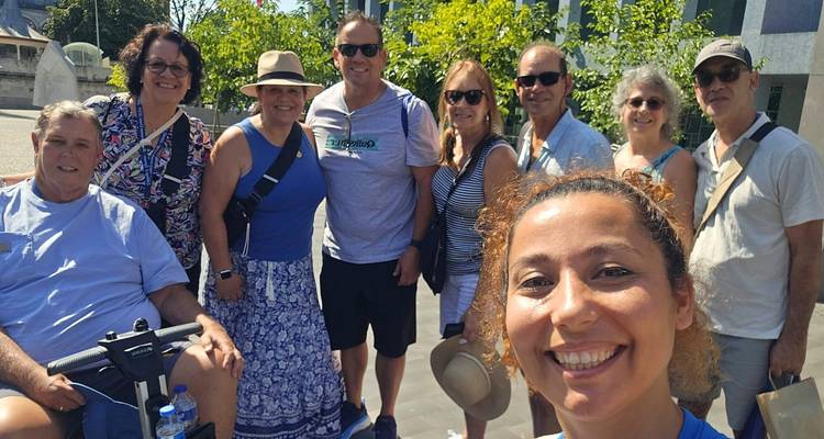 Group of people smiling outdoors on a sunny day.
