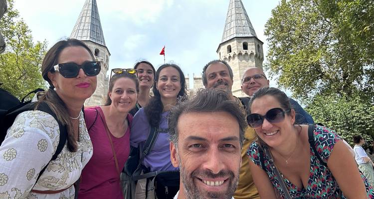 Group selfie in front of a historic structure with towers