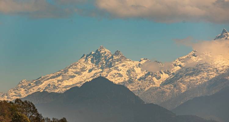Snow-capped mountains under a clear blue sky, prominent peaks visible.