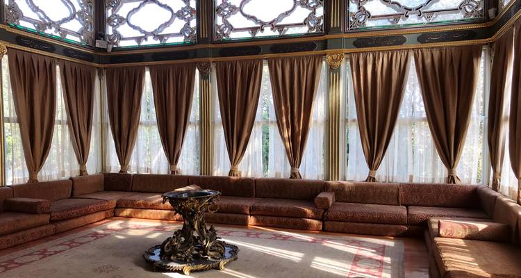 Habitación elegante con ventanas ornamentadas y cortinas.