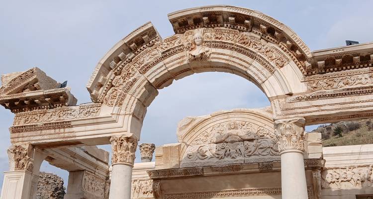 Ruines gréco-romaines antiques avec arche et colonnes détaillées.