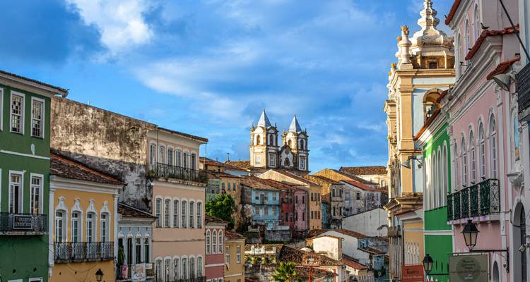 Bâtiments coloniaux colorés avec une église en arrière-plan.