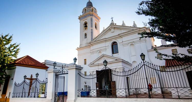 Église blanche avec un clocher et des arbres.