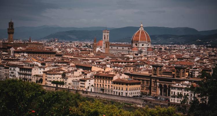 Expansive panorama of Florence’s terracotta rooftops with Duomo and tower against distant hills