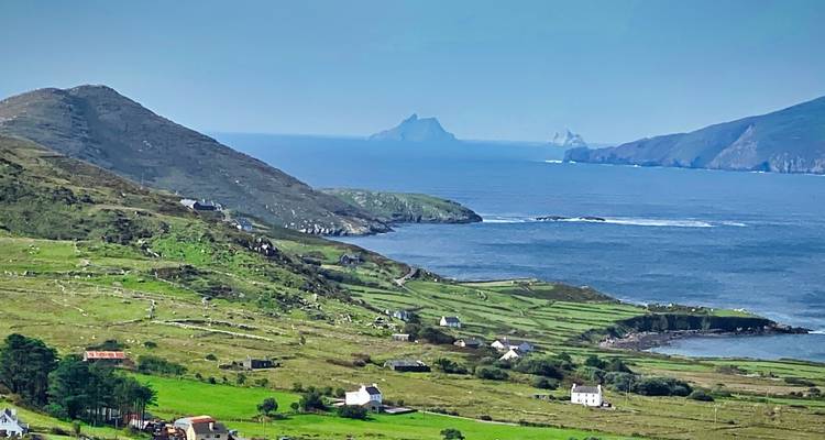 Green coastal hills overlooking Skellig islands and the Atlantic along the Ring of Kerry