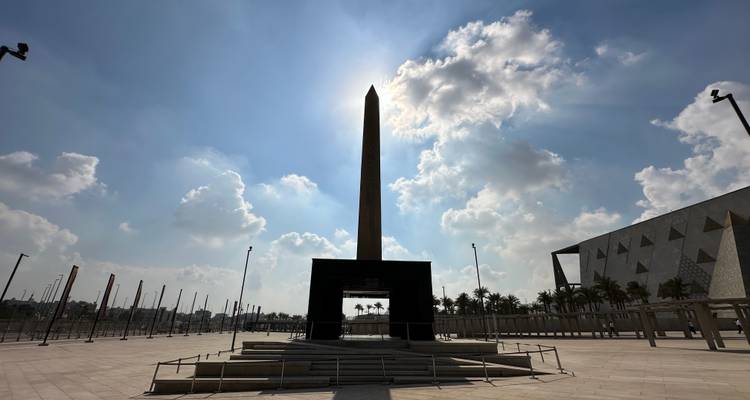 Ein hoher Obelisk, der sich gegen einen hellen Himmel zur Mittagszeit abzeichnet.