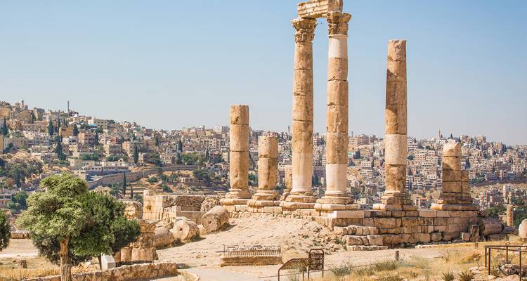 Ancient ruins of Amman Citadel with cityscape view in the background.
