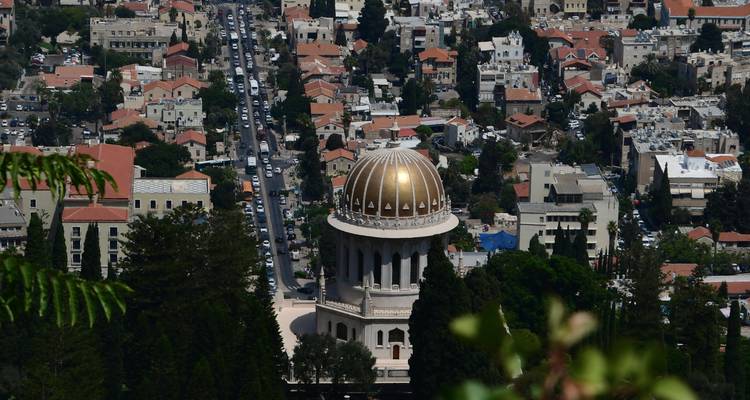 Golden-domed temple overlooking a dense Mediterranean cityscape