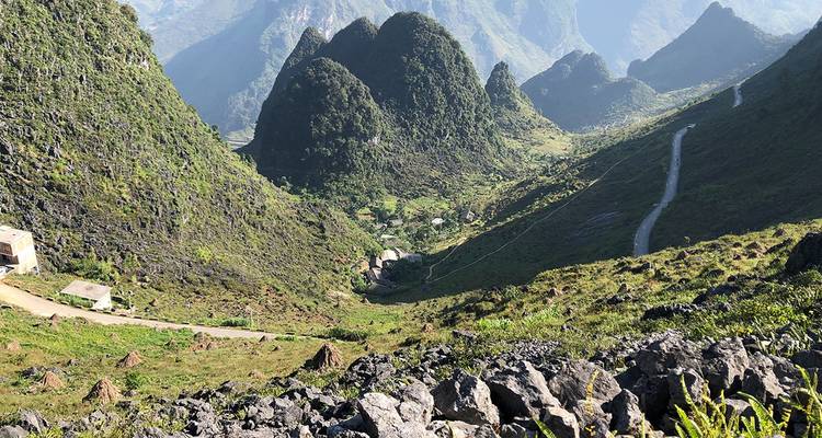 Bergachtig landschap met kronkelende wegen en weelderig groen.