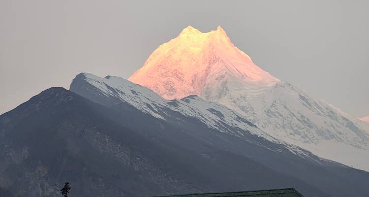 Sommet de montagne lumineux contre un ciel clair.
