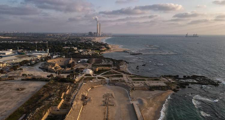 Aerial view of coastal ruins and amphitheatre beside the Mediterranean Sea