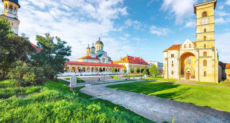 Sunny square with the Orthodox Coronation Cathedral and surrounding historic buildings in Alba Iulia