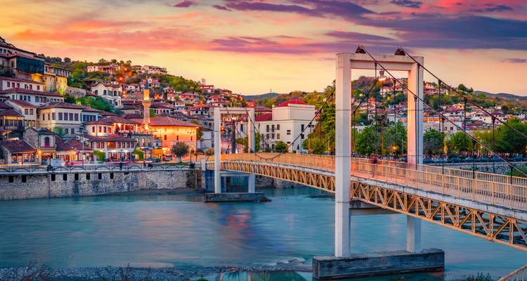 Golden sunset over the Osum River and Ottoman bridges of the hillside town of Berat.