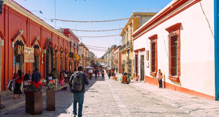 Street view in a city with colorful buildings and people.