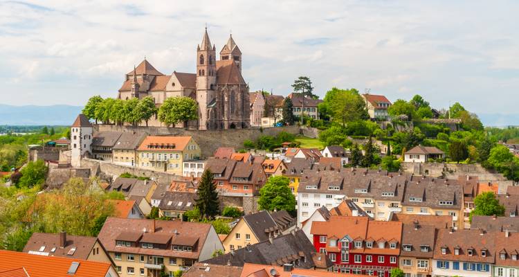 Hilltop cathedral and medieval walls overlook the quaint rooftops of Breisach, Germany.