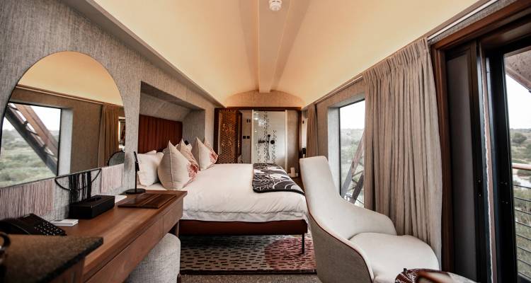 Luxurious hotel room inside a converted train carriage with panoramic windows
