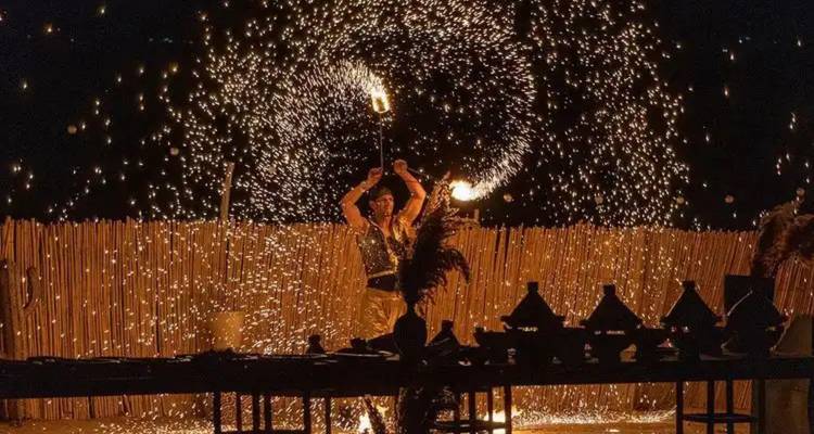 Person, die einen Feuertanz mit Funken in der Nacht aufführt.