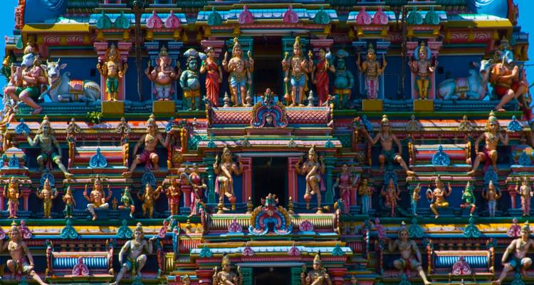 Vibrant, intricately carved temple facade with numerous statues.