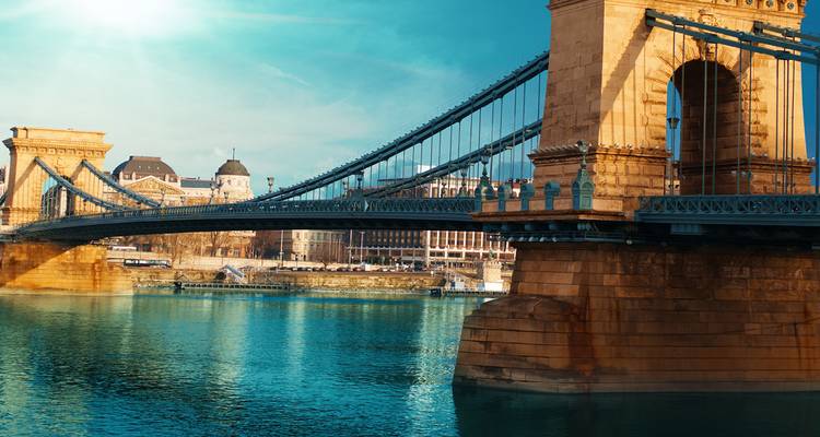 Close-up of the stone pillars and steel cables of Budapest’s Chain Bridge over the Danube on a sunny day