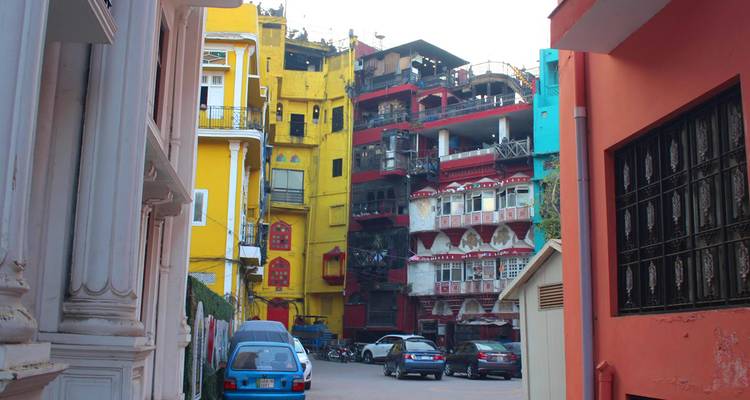 Colorful multi-storey buildings line a narrow street in Lahore’s vibrant old town.