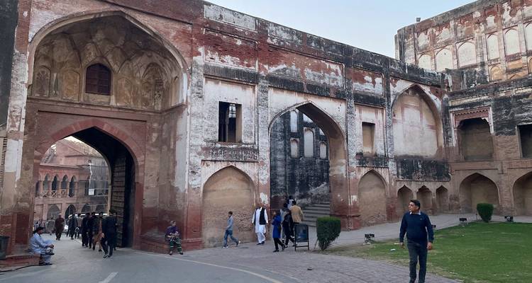 Visitors wander inside arcaded red-brick sections of Lahore Fort.