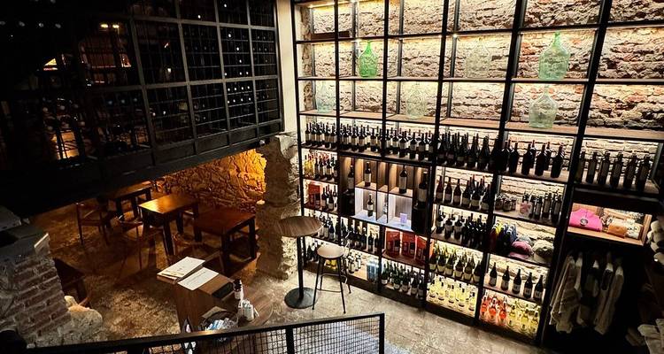 Stylish brick-walled wine shop packed with neatly displayed bottles and tasting tables.