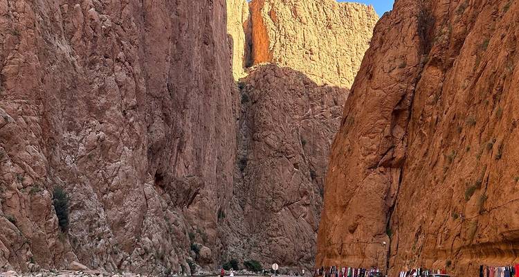 Torenhoge roestkleurige kliffen van de Todra-kloof doen de kleine bezoekers eronder in het niet verdwijnen