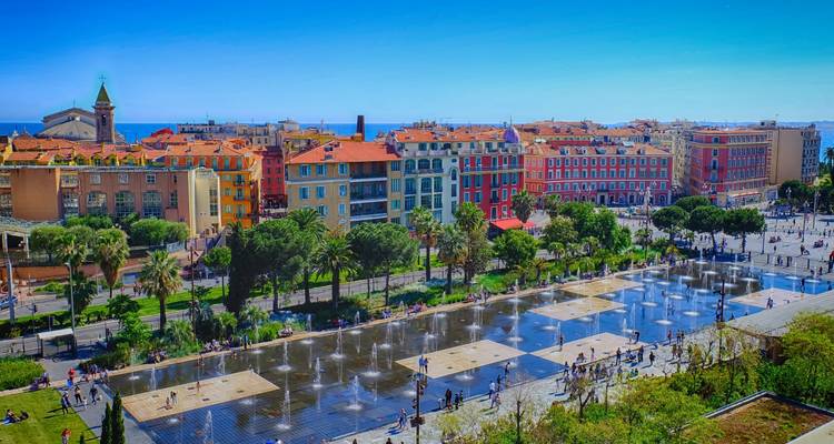 Lively Promenade du Paillon park in Nice with playful water jets, colorful facades and visitors strolling.