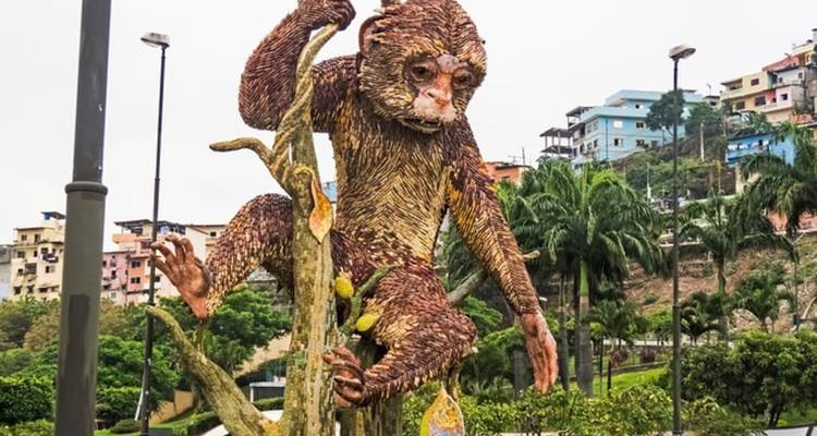 Colorful mosaic sculpture of a monkey climbing a tree trunk in an urban park.
