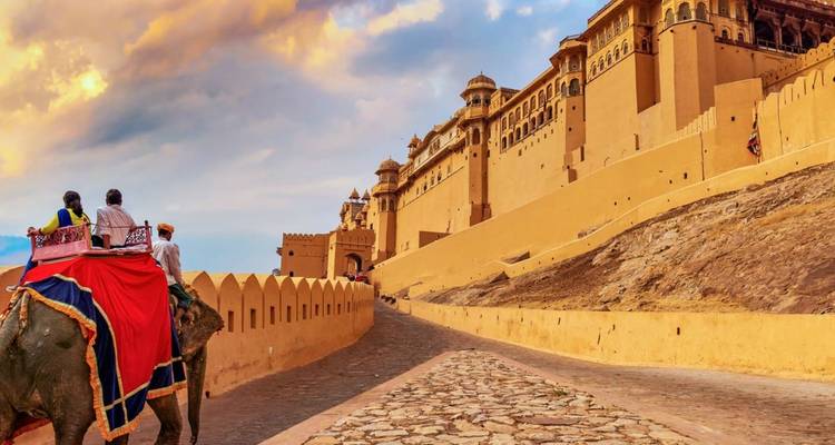 Tourists riding decorated elephants up the ramp to Amber Fort’s towering sandstone walls.
