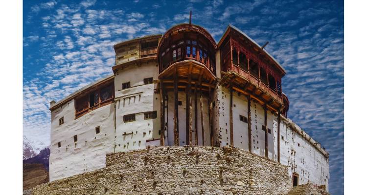 El histórico Fuerte Baltit se alza contra un cielo dramático surcado de nubes.