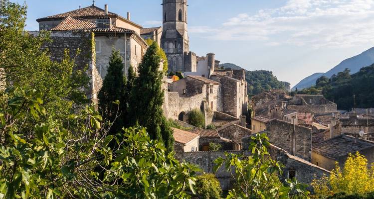 Pittoresque village perché provençal avec maisons en pierre et clocher niché parmi le feuillage verdoyant