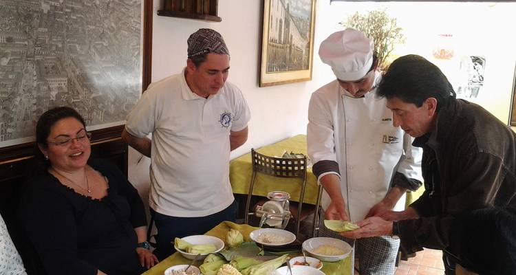 Chef guiding guests through a hands-on cooking lesson at a local restaurant.