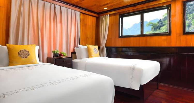 Cabaña con dos camas individuales, muy luminosa, con paneles de madera y una gran ventana con vistas a los picos de piedra caliza.