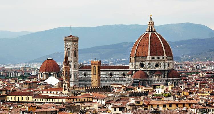 Panoramic skyline of Florence dominated by the red-tiled Duomo and Giotto's Campanile.