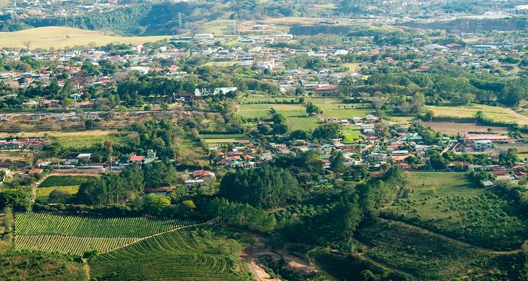 Patchwork of farms and suburban houses spread across a fertile valley