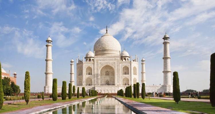 Iconic frontal view of the Taj Mahal with reflecting pool and blue sky