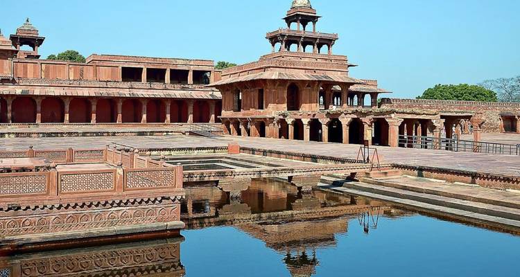 Panch Mahal pavilion reflected in tranquil water inside Fatehpur Sikri