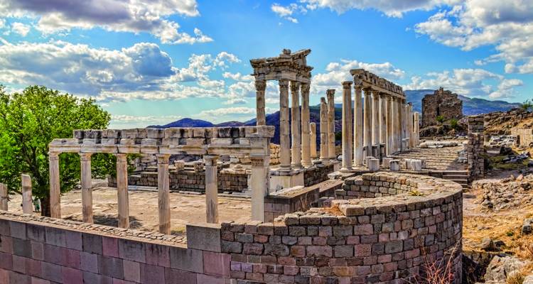 Ruinen der antiken Pergamon-Akropolis mit Säulen und Steinmauern unter einem teilweise bewölkten Himmel.