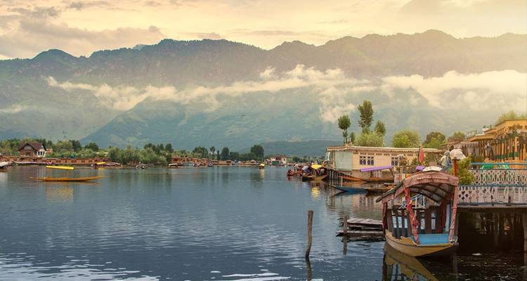 Lumière du soir sur le lac Dal avec des shikaras et les montagnes brumeuses du Pir Panjal.