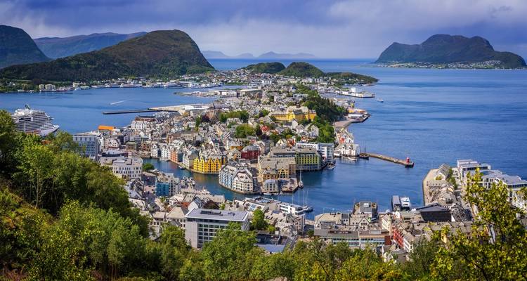 Picturesque coastal city of Ålesund with colorful buildings and surrounding islands viewed from above.