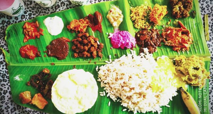 A colourful Kerala feast served on a banana leaf features rice, curries and pickles.